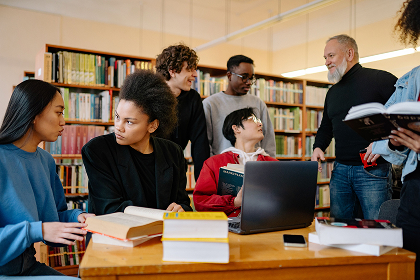 Students studying together with books in the library